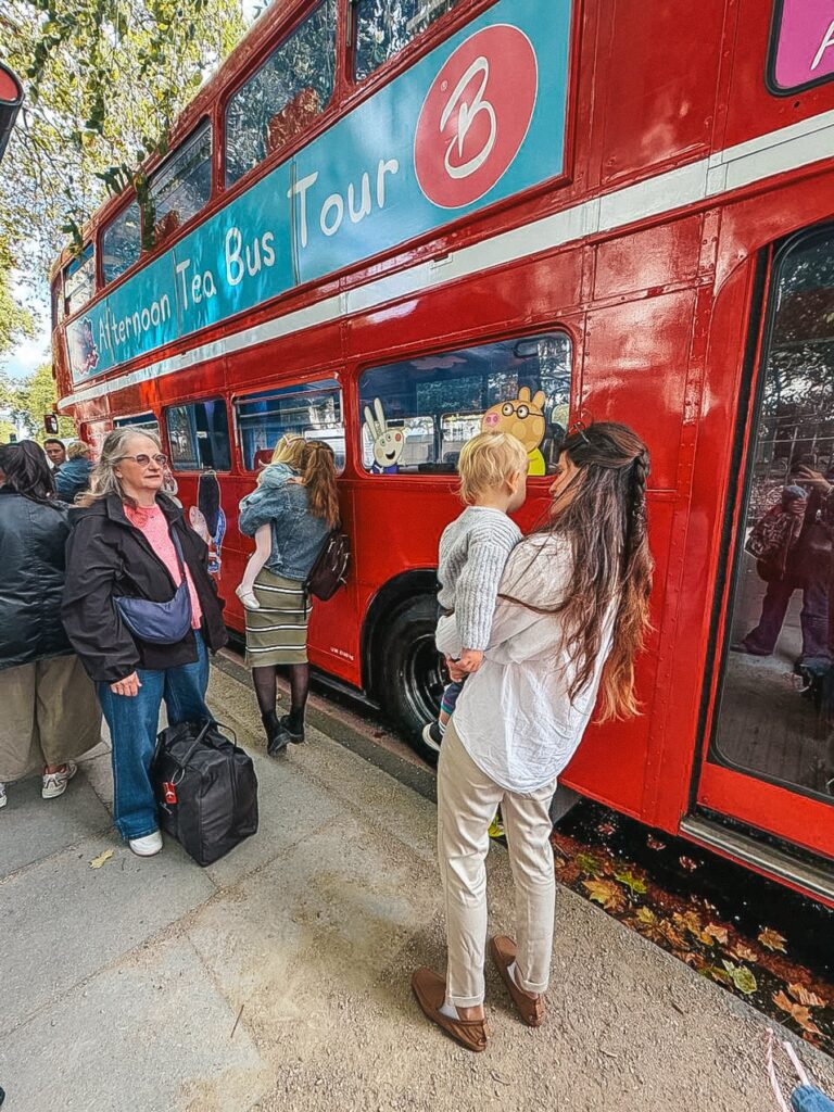 Boarding the Peppa Pig afternoon tea bus tour at Temple, Bus Stop N, on Victoria Embankment