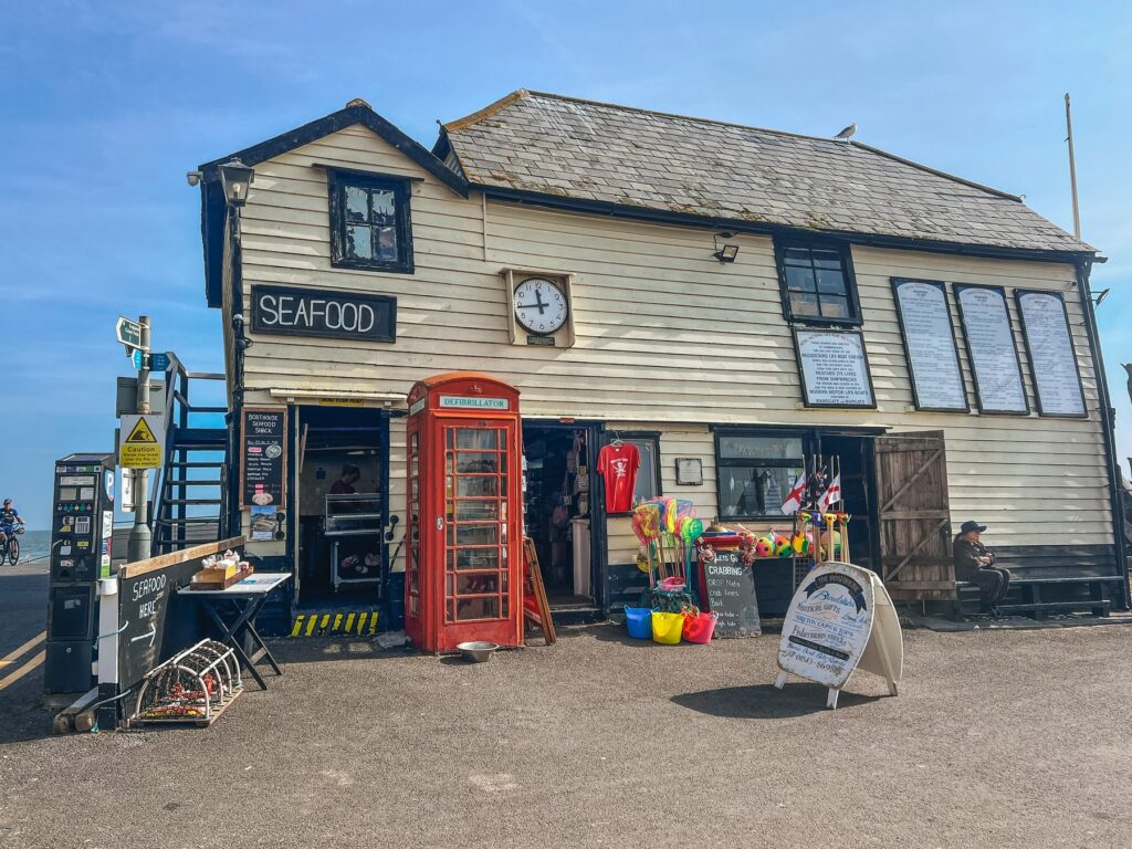 Boathouse Seafood Shack at Broadstairs harbour with a red telephone box and crabbing nets