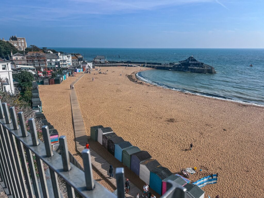View over Viking Bay beach in Broadstairs with the boardwalk, beach huts and harbour jetty