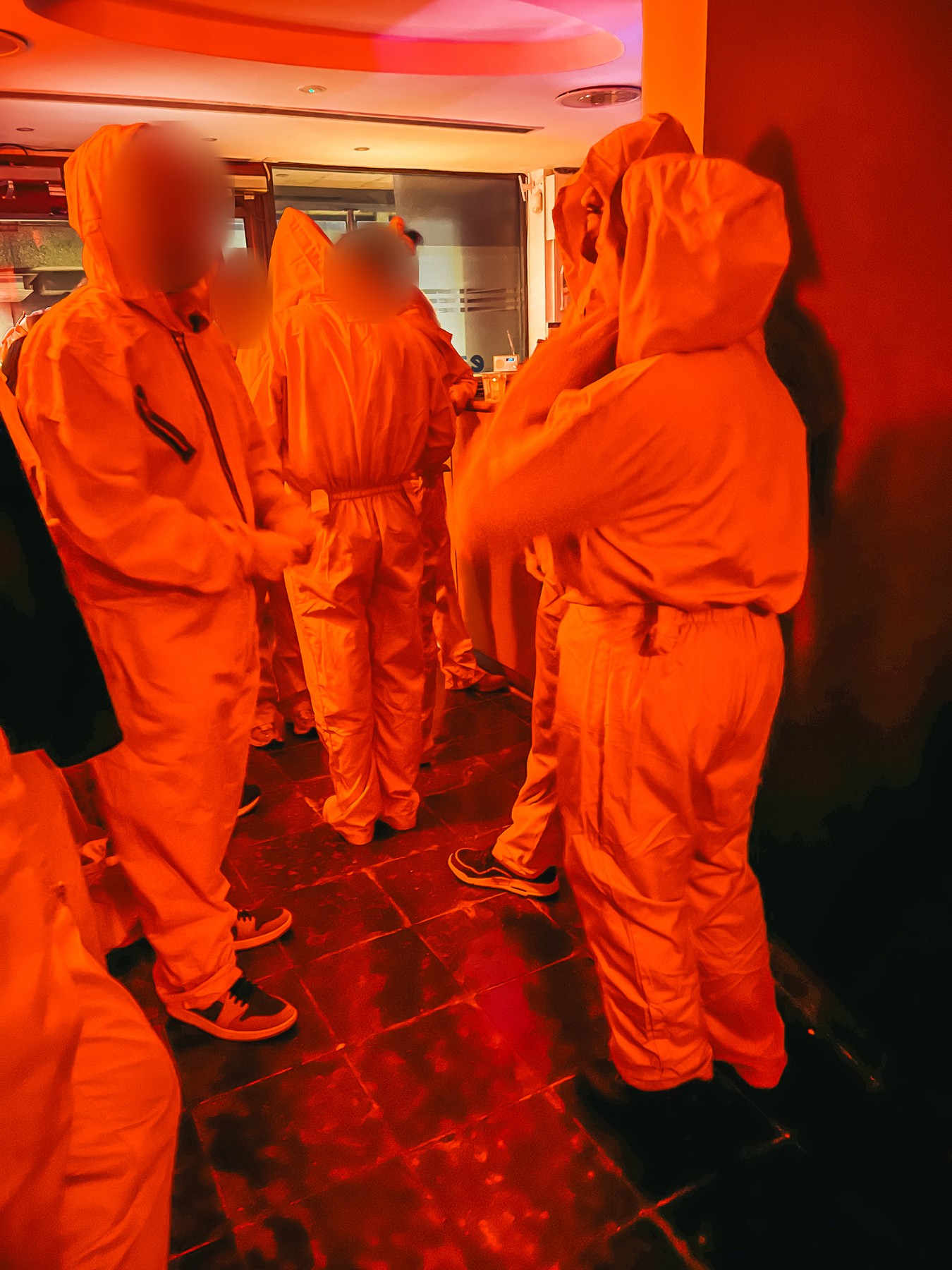 Guests in orange overalls at SPORE London immersive horror
