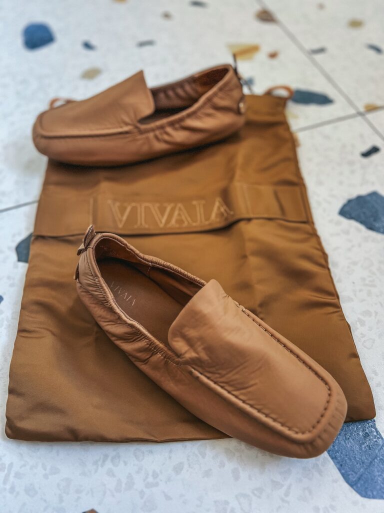 Vivaia Avoir travel loafers on their storage bag